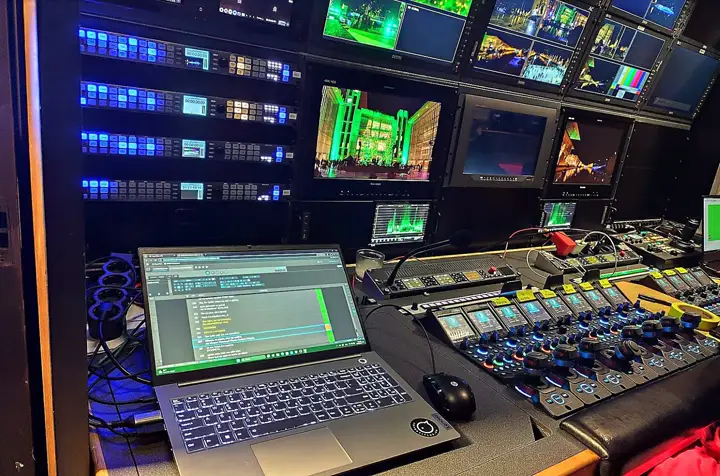 Cues on a laptop, the stage on the monitors behind.